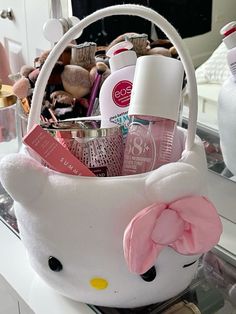 a white hello kitty basket filled with cosmetics and personal care items on a counter top