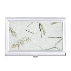 a business card case with an image of leaves on the front and bottom, in white