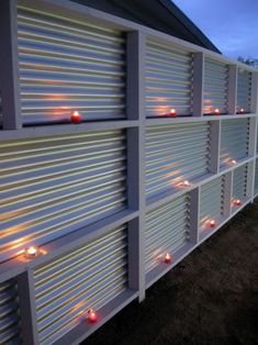 candles are lit on the side of a building