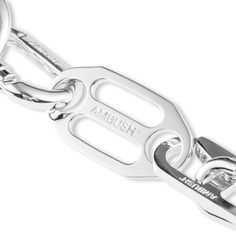 AMBUSH® began as an experimental line of jewelry – innovative pop art inspired designs capturing a distinct Tokyo aesthetic. The iconic trademarked POW!® motif in particular received media coverage around the world. With apparel created as a can-vas to complete the story, AMBUSH® evolved into designing unisex collections. Pictured is the Ambush Carabiner 1 Necklace in Silver. Brass composition Silver tone hardware Clasp fastening Engraved branding Style no: 12111855 Ambush Jewelry, Carabiner Jewelry, Trouser Chain, Chrome Hearts Jewelry, Tokyo Aesthetic, Complete The Story, Hardware Jewelry, Media Coverage, 3d Artwork