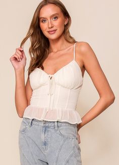 Effortlessly elevate your wardrobe with our Ivory Smocked Back Corset Top. Dress it up for a special occasion or dress it down for a casual day out. Style it alone for a chic look or layer it with a blazer for a touch of sophistication. Delicate frilly hem and cami straps add a feminine touch to this versatile piece. Available in Small, Medium and Large Runs true with smocked back for a flattering stretchy fit Corset Top Dress, Chic Look, Days Out, Corset Top, Top Dress, Concert Outfit, Smocking, Shirts Tops, Special Occasion