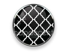 a black and white button with an intricate pattern