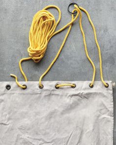 a yellow rope is attached to a white bag