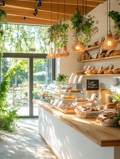 a bakery with lots of food and plants hanging from the ceiling in front of it