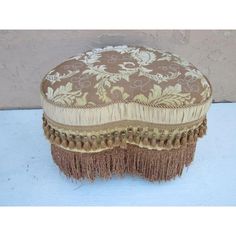 a brown and white ottoman sitting on top of a table