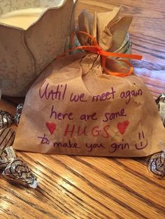 a bag with writing on it sitting next to some chocolate candies and a glass of milk