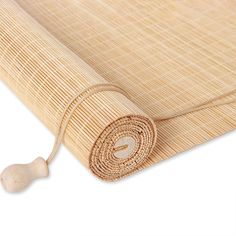 a roll of bamboo is laying on top of the mat, which has been rolled down