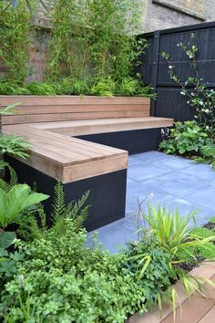 a wooden bench sitting in the middle of a garden