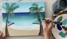 someone is painting a tropical scene with palm trees