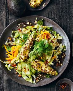 a plate filled with salad next to two other plates