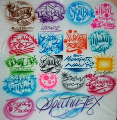 the back side of a t - shirt that has various lettering on it, all in different colors