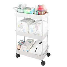 a baby changing cart with diapers and blankets on it's wheels, in front of a white background