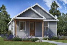 a small gray house sitting on top of a lush green field