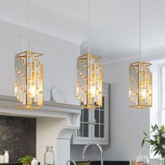 three lights hanging from the ceiling in a kitchen