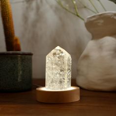 a white crystal standing on top of a wooden table