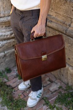 Introducing our Handmade Italian Leather Briefcase, a perfect blend of luxury and functionality. Crafted from the finest Tuscan vacchetta leather, this briefcase embodies the rich heritage and artisanal skill of Montepulciano. Designed for the modern professional, it offers ample space for your laptop and essential documents, making it an ideal companion for business and daily use. Features:  ● Premium Material: Made from 100% genuine Tuscan vacchetta leather, known for its durability and timele Business Bags With Coin Pocket And Rectangular Shape, Brown Business Bags With Coin Pocket, Luxury Cognac Briefcase For Business, Luxury Bridle Leather Briefcase For Formal Use, Elegant Business Bags With Coin Pocket, Formal Cognac Cases With Leather Lining, Elegant Brown Bag With Coin Pocket, Italian Leather Briefcase For Formal Use, Business Cases With Leather Lining In Cognac