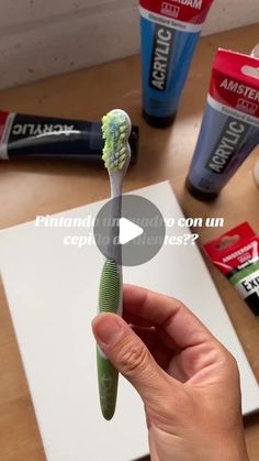 a person holding a toothbrush in their hand