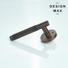 a metal object on a white surface with the words design max above it