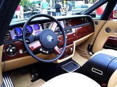 the interior of a luxury car with leather and wood trims, including steering wheel