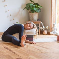 a woman laying on the floor with her feet up