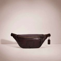 a brown leather fanny bag sitting on top of a table