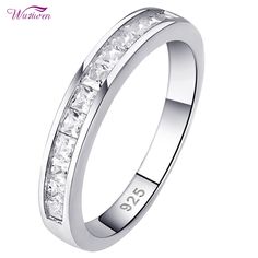 a white gold wedding ring with princess cut diamonds on the outside and side stones in the middle