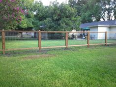 a wooden fence in the middle of a yard