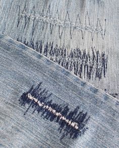 the back side of an old pair of jeans with holes in it and stitching on them