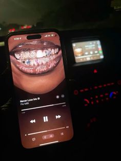 a cell phone with an image of a woman's mouth and teeth on it