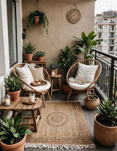 a balcony with potted plants and wicker furniture on the floor, along with rugs