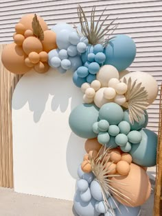 a bunch of balloons that are hanging on a wall