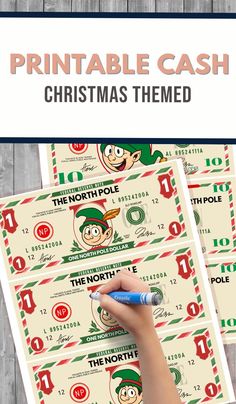 the printable cash christmas themed game is being played on a wooden table with pencils and