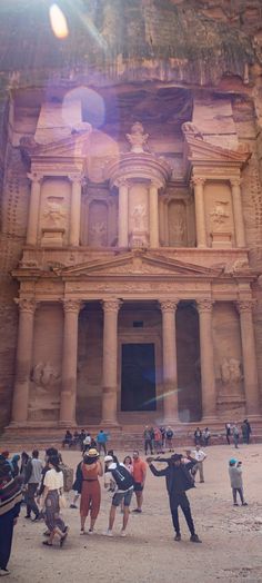 people standing in front of an ancient building