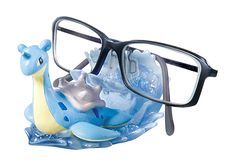 a pair of glasses sitting on top of a fake animal