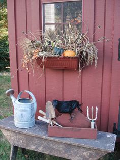 a potted plant sitting on top of a wooden table next to a watering can