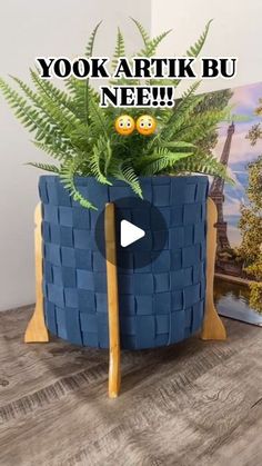 a potted plant sitting on top of a wooden table next to a video screen