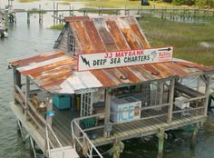 a boat dock with a house on the water