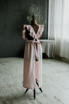 a mannequin wearing a pink dress with ruffles