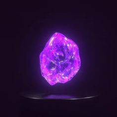 a purple diamond is glowing in the dark