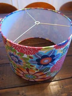 a lamp shade sitting on top of a wooden table