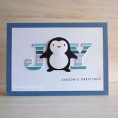 a penguin card with the words season's greetings written in white and blue