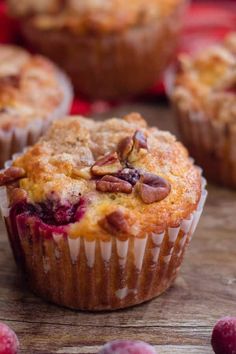 three muffins on a plate with cinnamon and apples