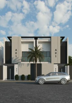 a silver car parked in front of a white building with palm trees on the side