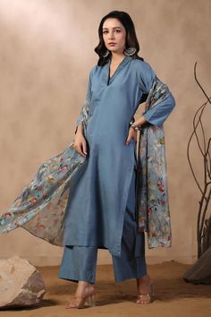 Denim blue A-line kurta with pleated neckline. Comes with cotton silk pant and floral printed dupatta.
Components: 3
Pattern: Printed
Type Of Work: Floral
Neckline: V Neck
Sleeve Type: Three Quarter
Fabric: Cotton Silk
Color: Blue
Other Details: 
Attached lining
Approximate product weight: 0.5-1 kg
Occasion: Work - Aza Fashions Cotton Palazzo Set With Dabka, Unstitched Cotton Silk Sets For Spring, Designer Cotton Lawn Suit For Summer, Spring Cotton Dupatta With Dabka Detail, Blue Designer Palazzo Set For Spring, Light Blue Long Sleeve Lawn Suit For Summer, Elegant Blue Cambric Dress, Blue Straight Kurta Lawn Suit In Mulmul, Cotton Blue Dupatta With Dabka