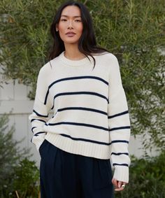 Chloe Crewneck Ivory/Navy Stripe In 100% Peruvian cotton, it’s a classic silhouette in a casual, slightly cropped style—perfect for welcoming warmer weather. The beauty of this knit is its versatility in styling. Wear it with shorts, over a dress, or with jeans for an instantly pulled-together look. White Striped Sweater Outfit, Striped Sweater Outfit, White Striped Sweater, Jenni Kayne, Sweater Outfit, American Life, Photoshoot Outfits, Cropped Style, Summer 24