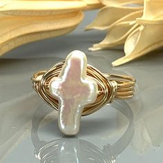 "White Cultured Pearl Cross and Sterling Silver, Yellow or Rose Gold Filled Wire Wrapped Ring; Custom Made to Size *This white cultured pearl cross bead and wire wrapped ring is handmade with an approximately 9mm by 13mm pearl bead and your choice of wire type for the band. *This ring (as well as all the others in my shop) is custom made to any size from 4 to 14 including half and quarter sizes! DIRECTIONS FOR CHECKOUT 1.) To checkout, please select the SIZE of the ring and your choice of BAND C Wire Crosses, Silver Wrap Ring, Wire Wrapped Ring, Hand Stamped Jewelry, Cross Ring, Wire Wrapped Rings, Jewelry Lookbook, Stamped Jewelry, Girly Jewelry