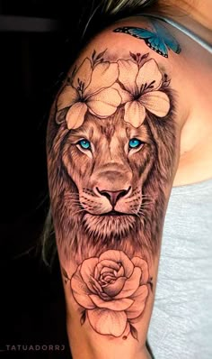 a woman's arm with a lion and flowers on it