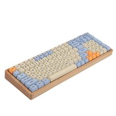 an old computer keyboard with blue and orange keys on it's side, in front of a white background