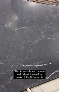 a large black marble slab with a quote on it that says, this is misty honed granite and i think it would be perfect really beautiful