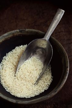 a bowl filled with rice and a spoon